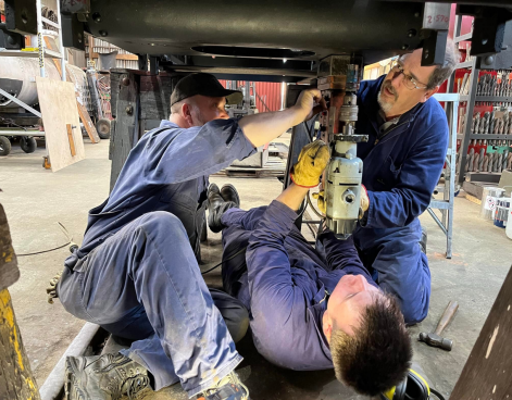 Drilling bolt holes for undercarriage water tank.