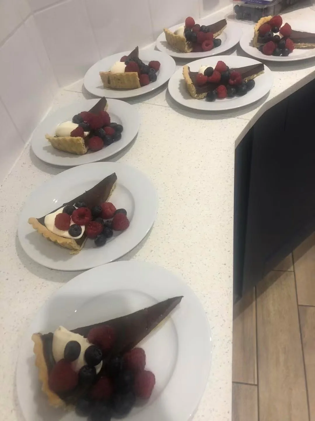 Dark chocolate tart served with mixed berries.