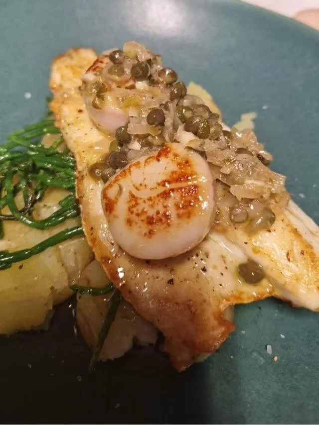 Seared seabass topped with a scallop served with Samphire in a caper and lemon butter