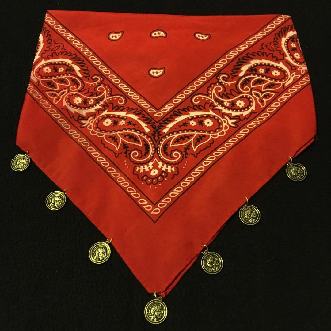 Red bandana with a paisley pattern and small gold coin charms along the edge.