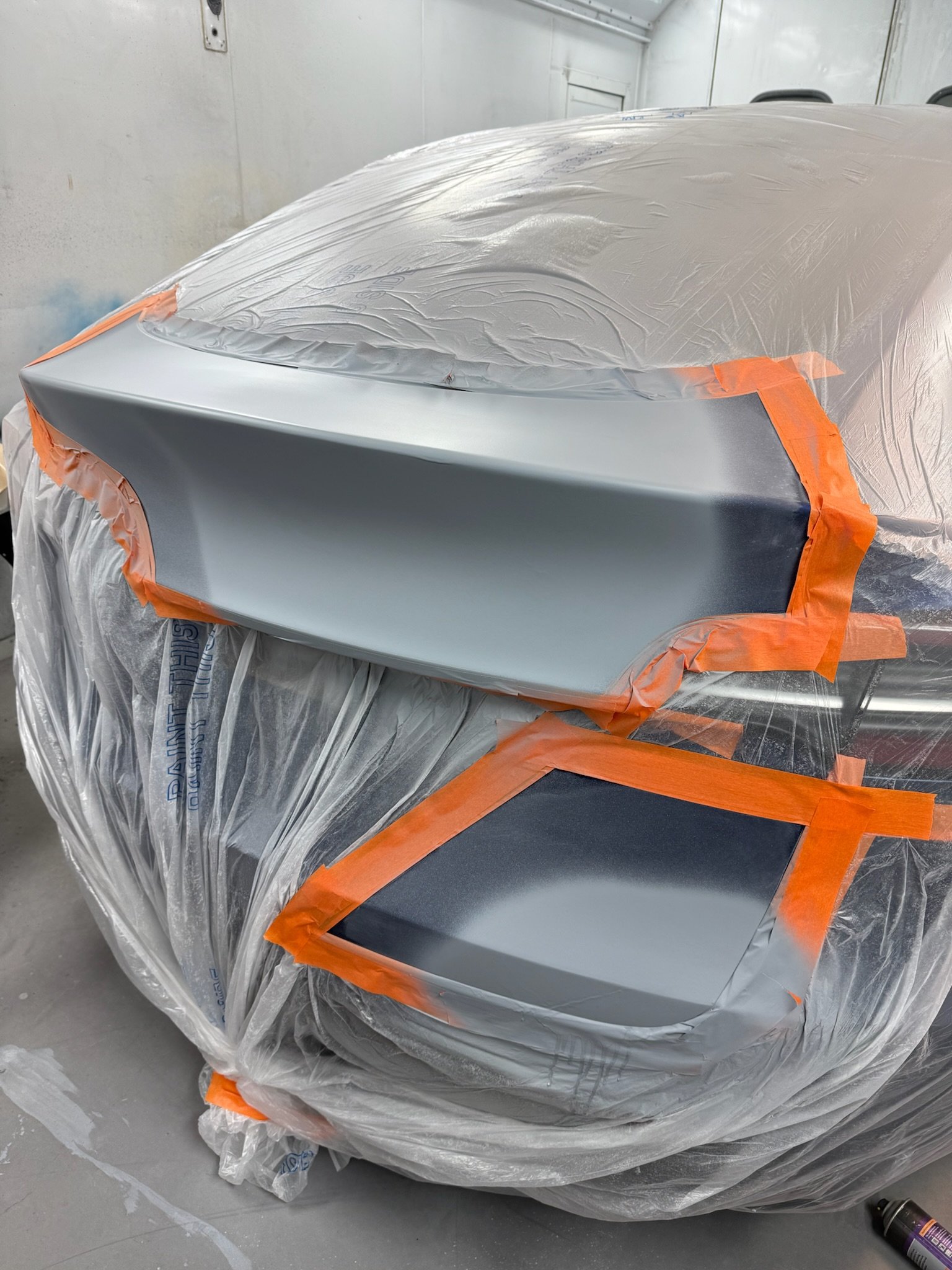 Vehicle panels primed and masked ready for spray painting
