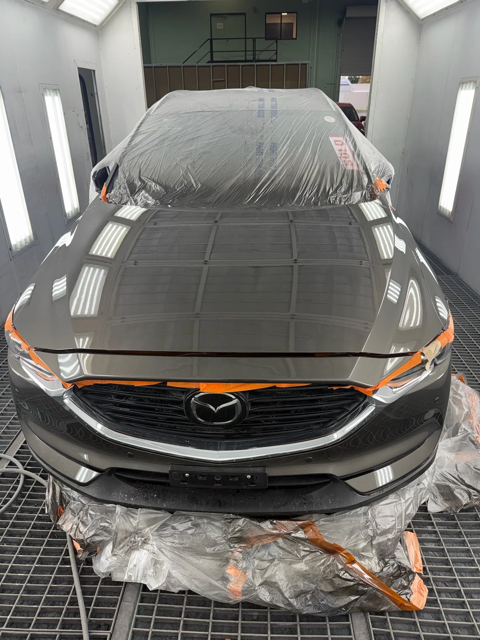 Mazda bonnet prepared for automotive spray painting