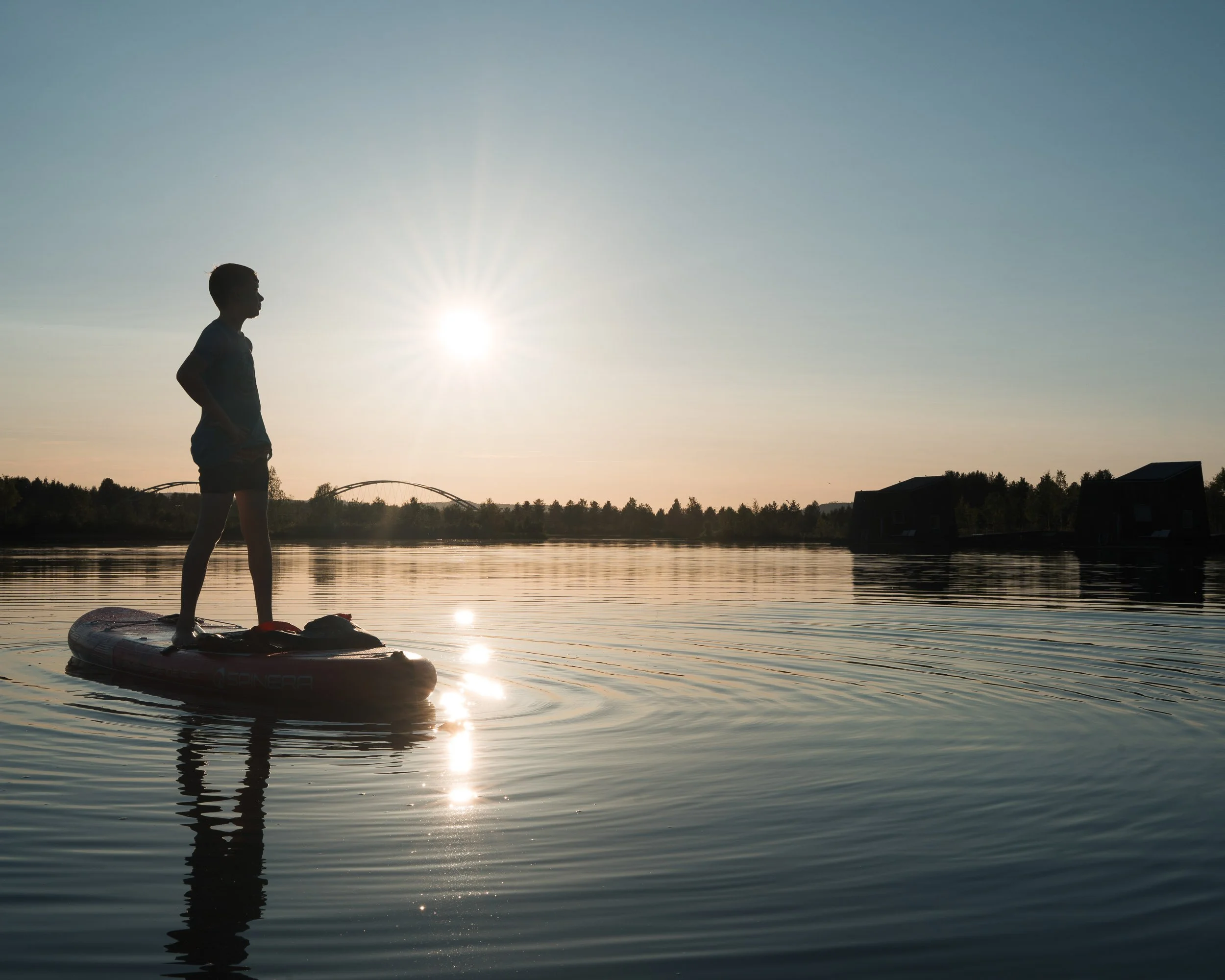 boy standing on a paddle board at Arctic Bath, Sweden, hotel photography