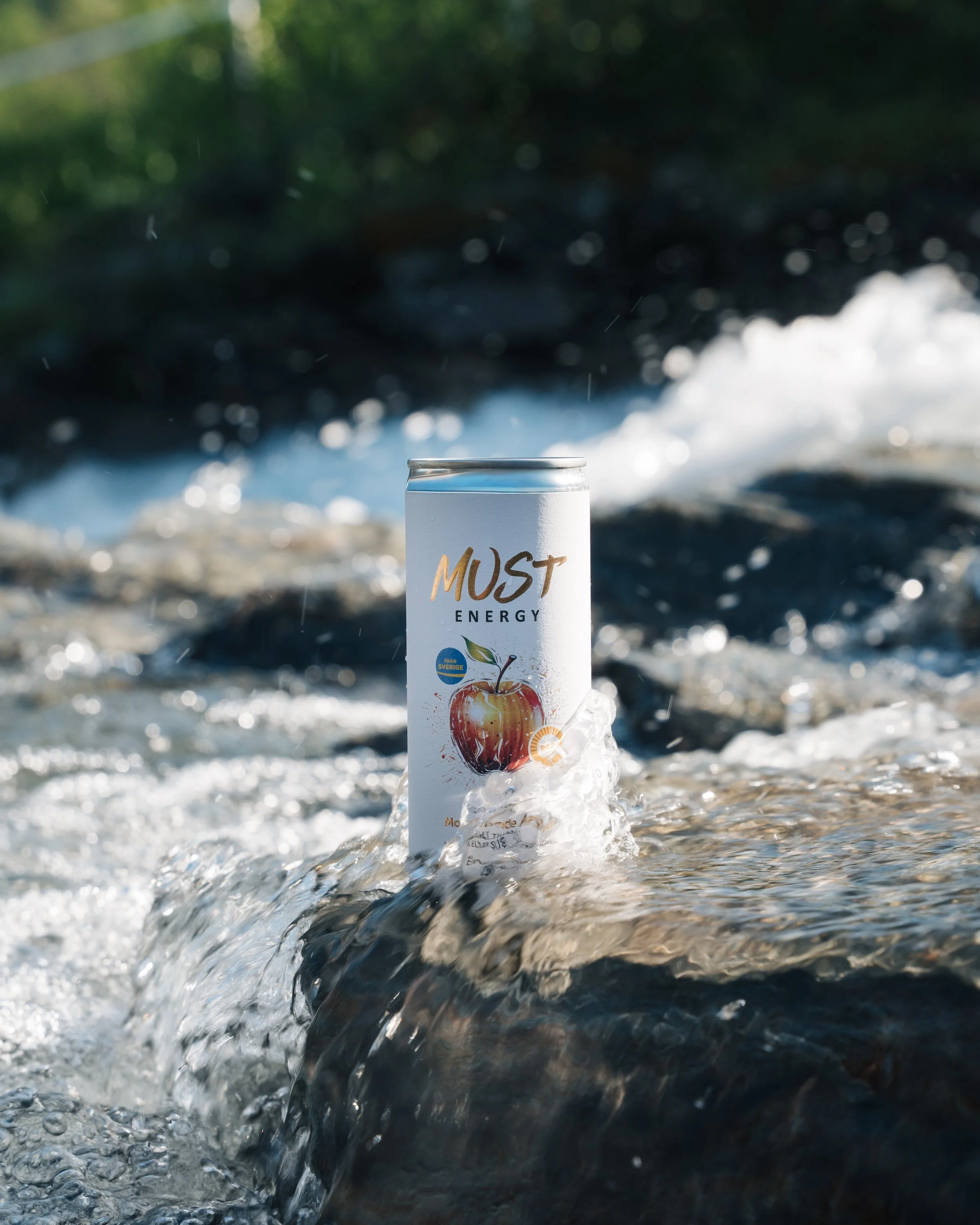 can of must energy in a waterfall in Abisko national park