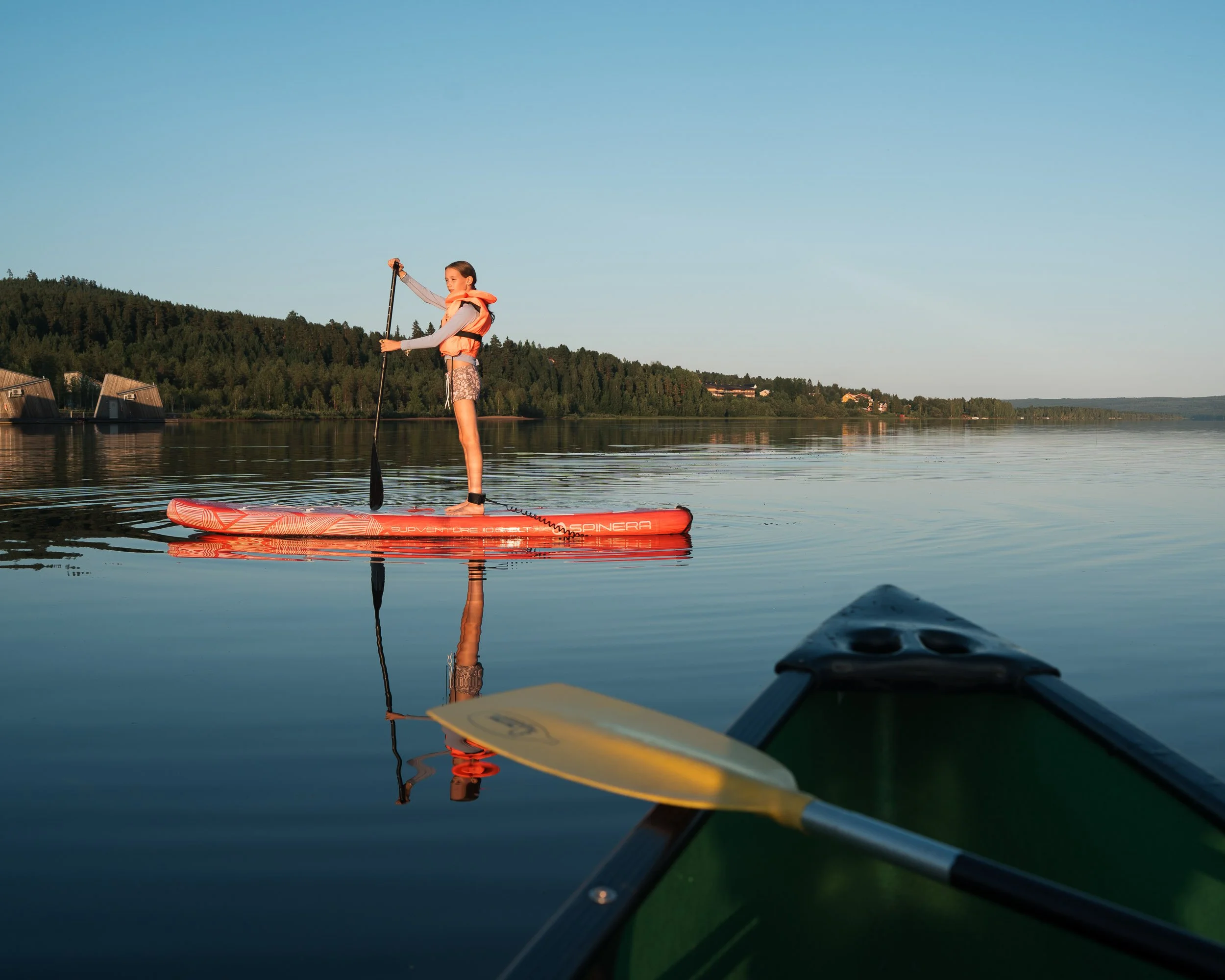 girl paddle boarding at Arctic Bath Hotel, Sweden, commercial photography shoot