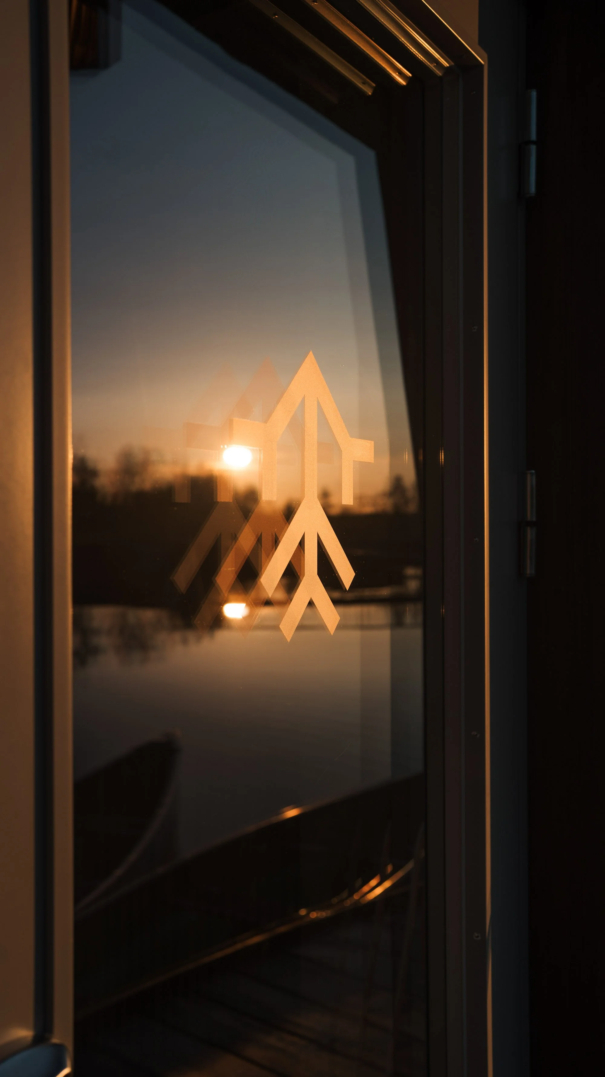 Arctic Bath logo with the sun setting in the reflection photographed for a brand campaign