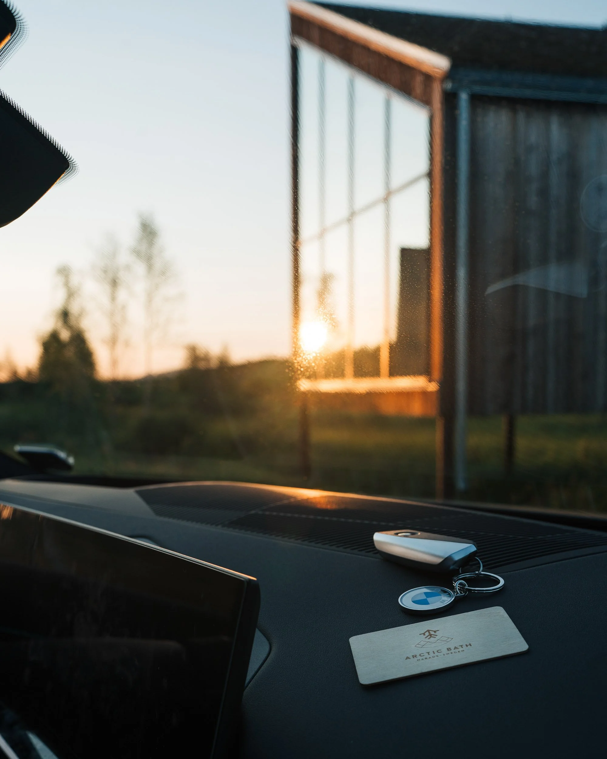 BMW with a Arctic Bath key card on the dash board outside the hotel. Commercial photography