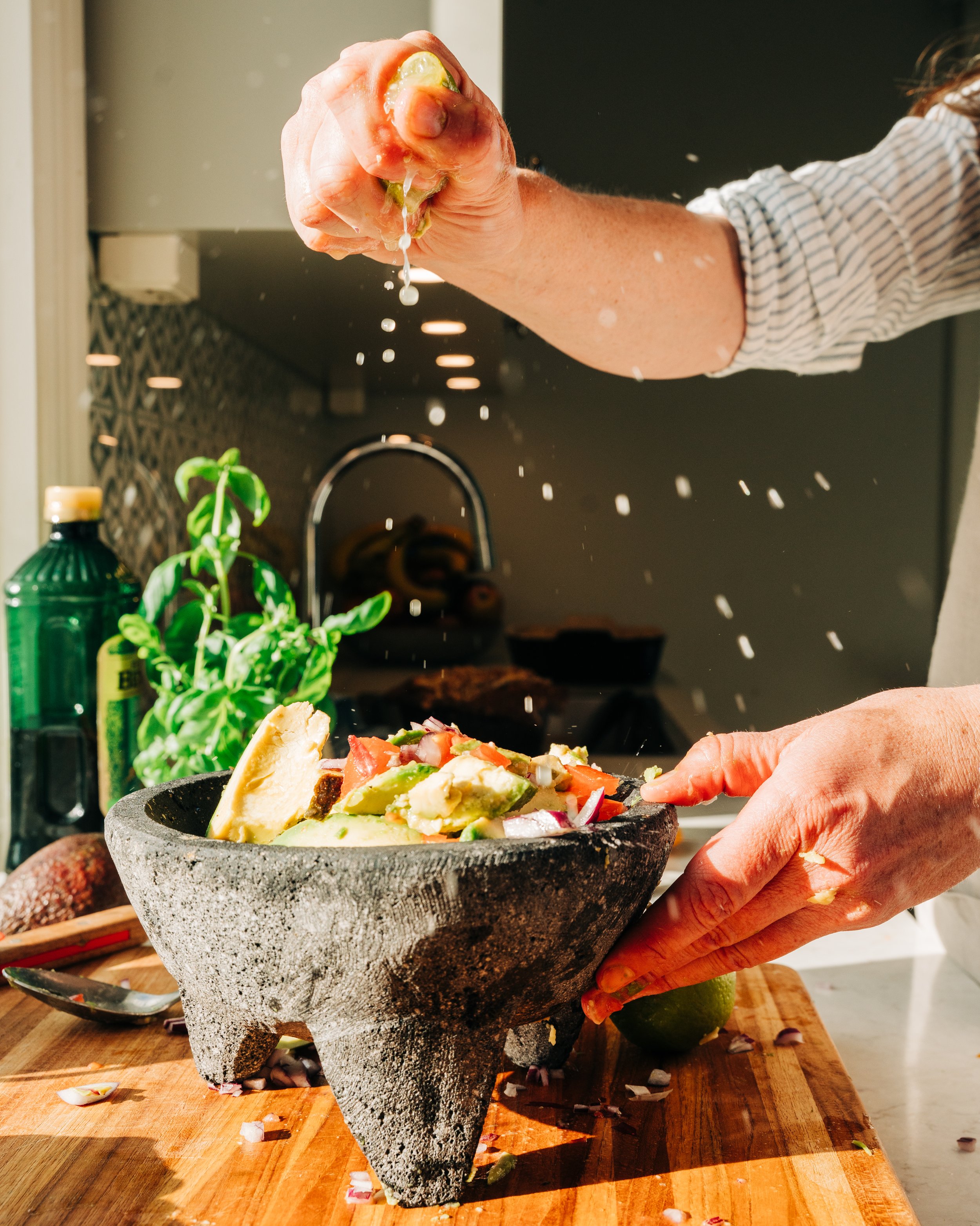 home chef squeezing limes over her cooking commercial photography