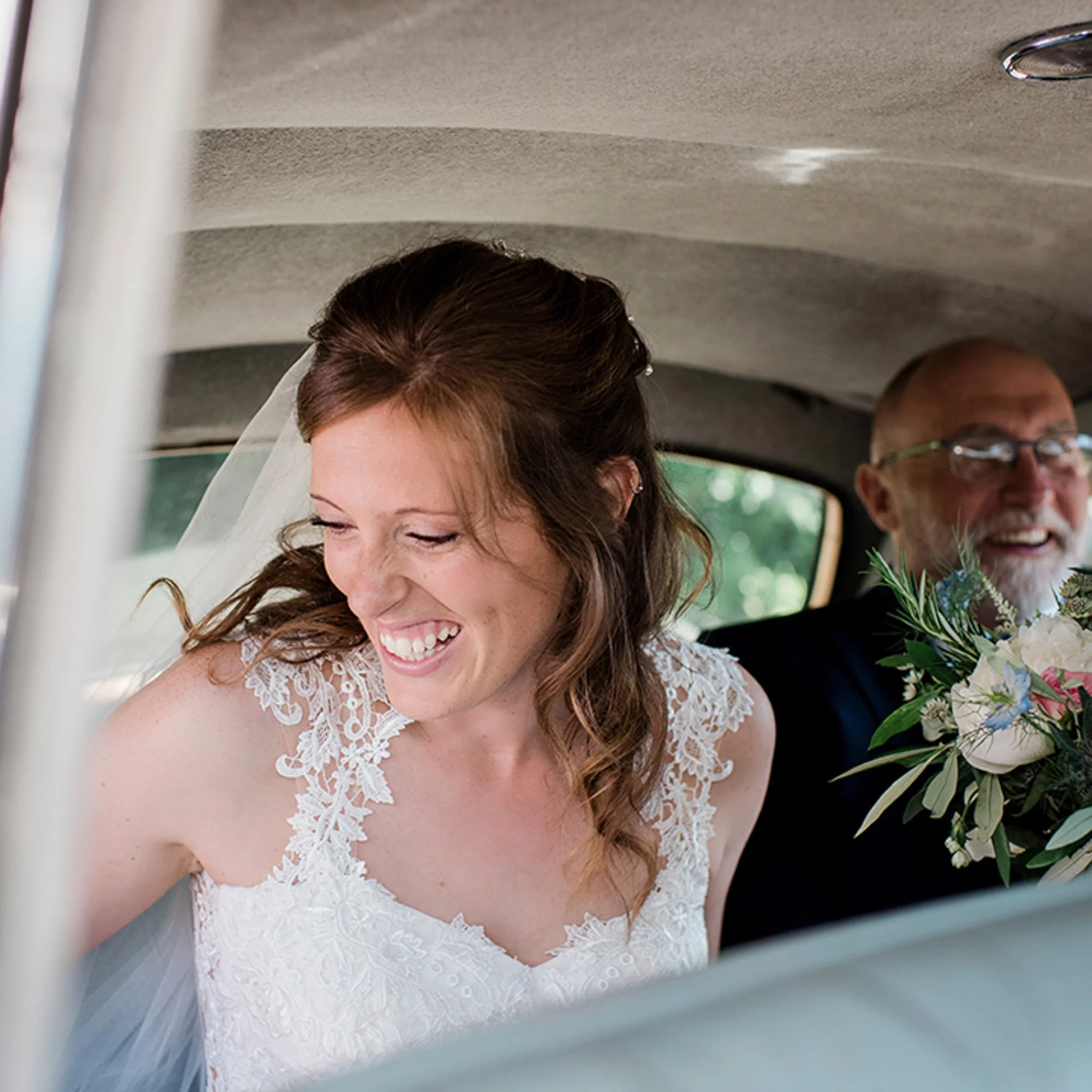 bride smiling in the car getting ready to get married in Stockholm