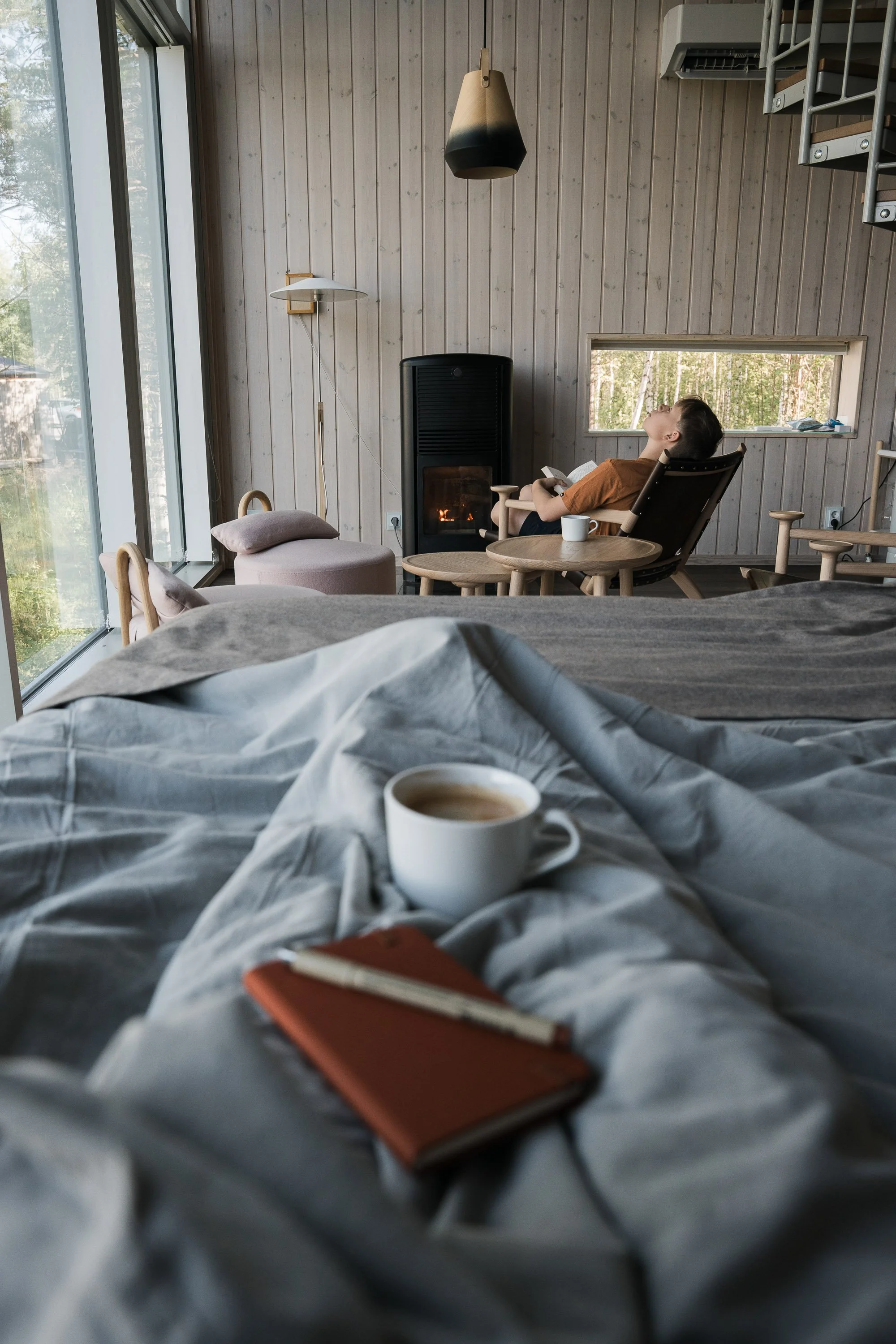 parents relaxing with a cup of coffee at the land cabin at Arctic Bath hotel, Sweden 