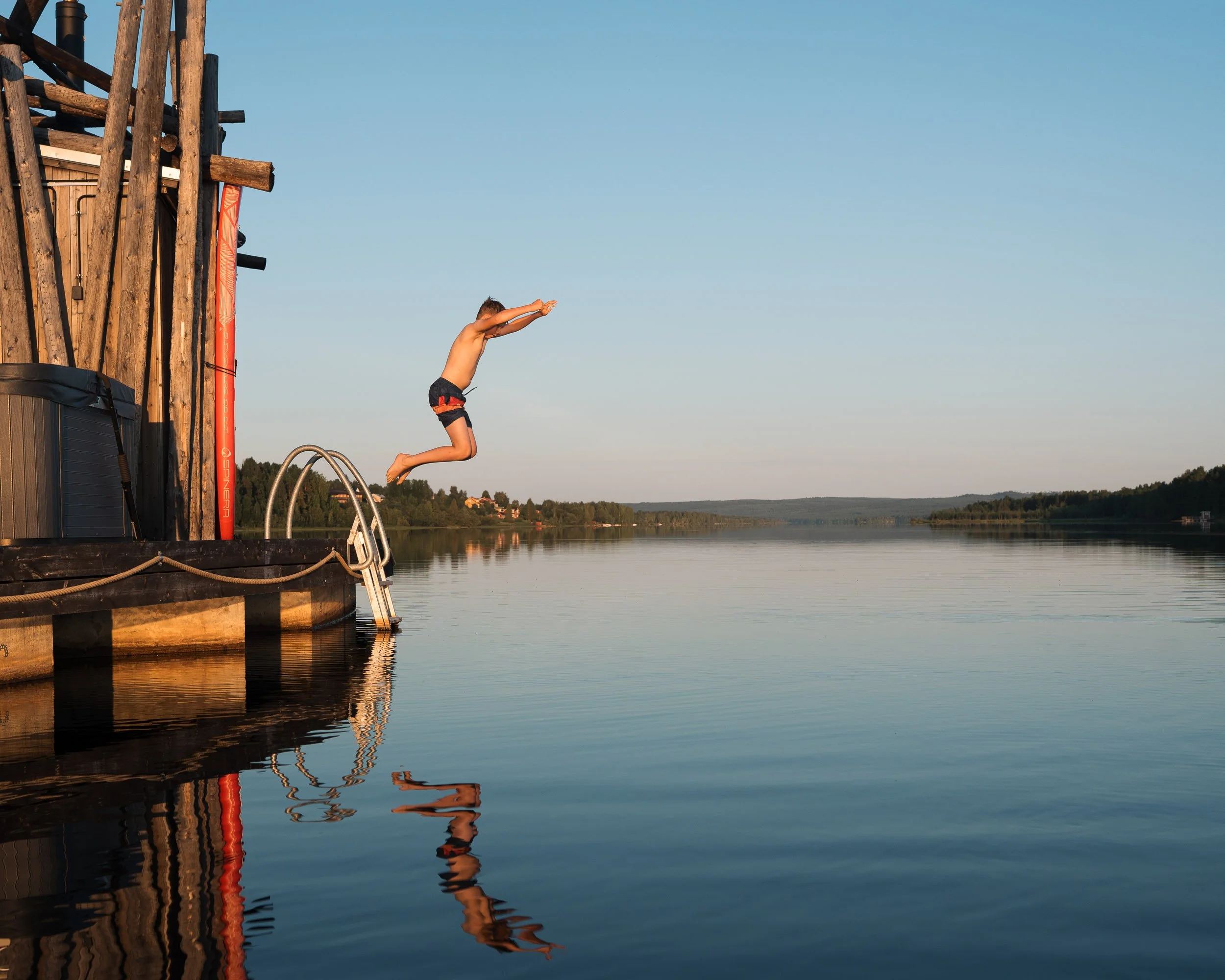 boy jumping into the sea at Arctic Bath hotel, Sweden, lifestyle photography