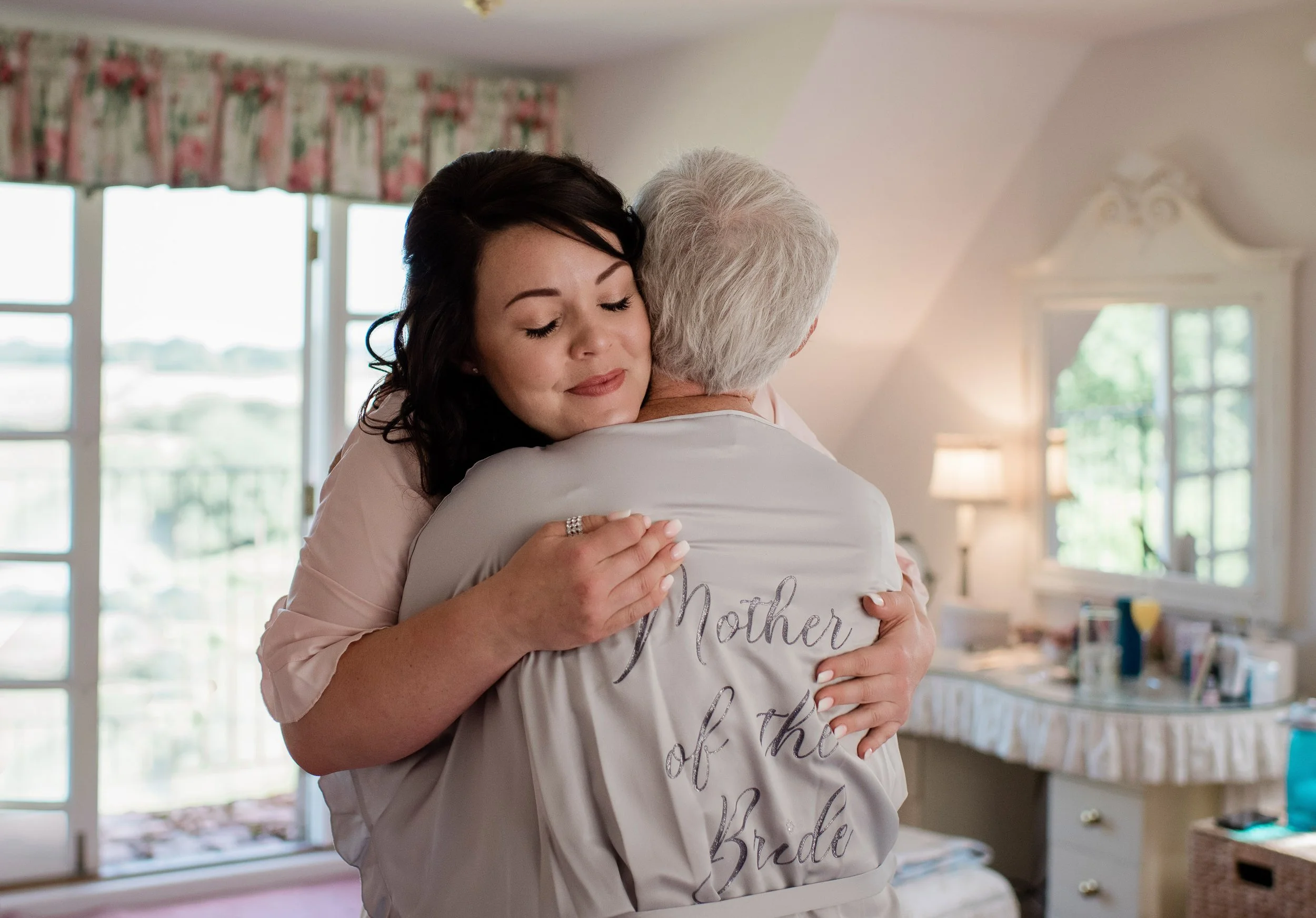 mother of the bride hugging the bride before getting married in Stockholm, Sweden