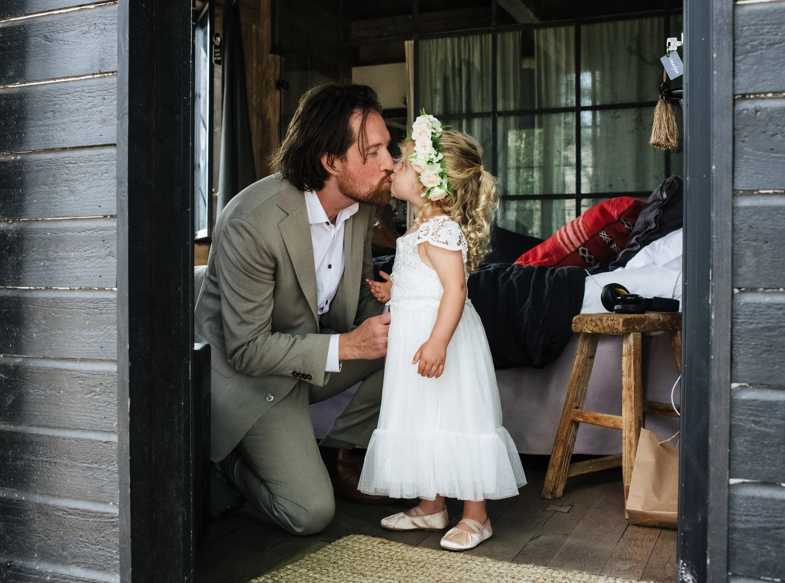 groom kissing his daughter on his wedding day in Stockholm