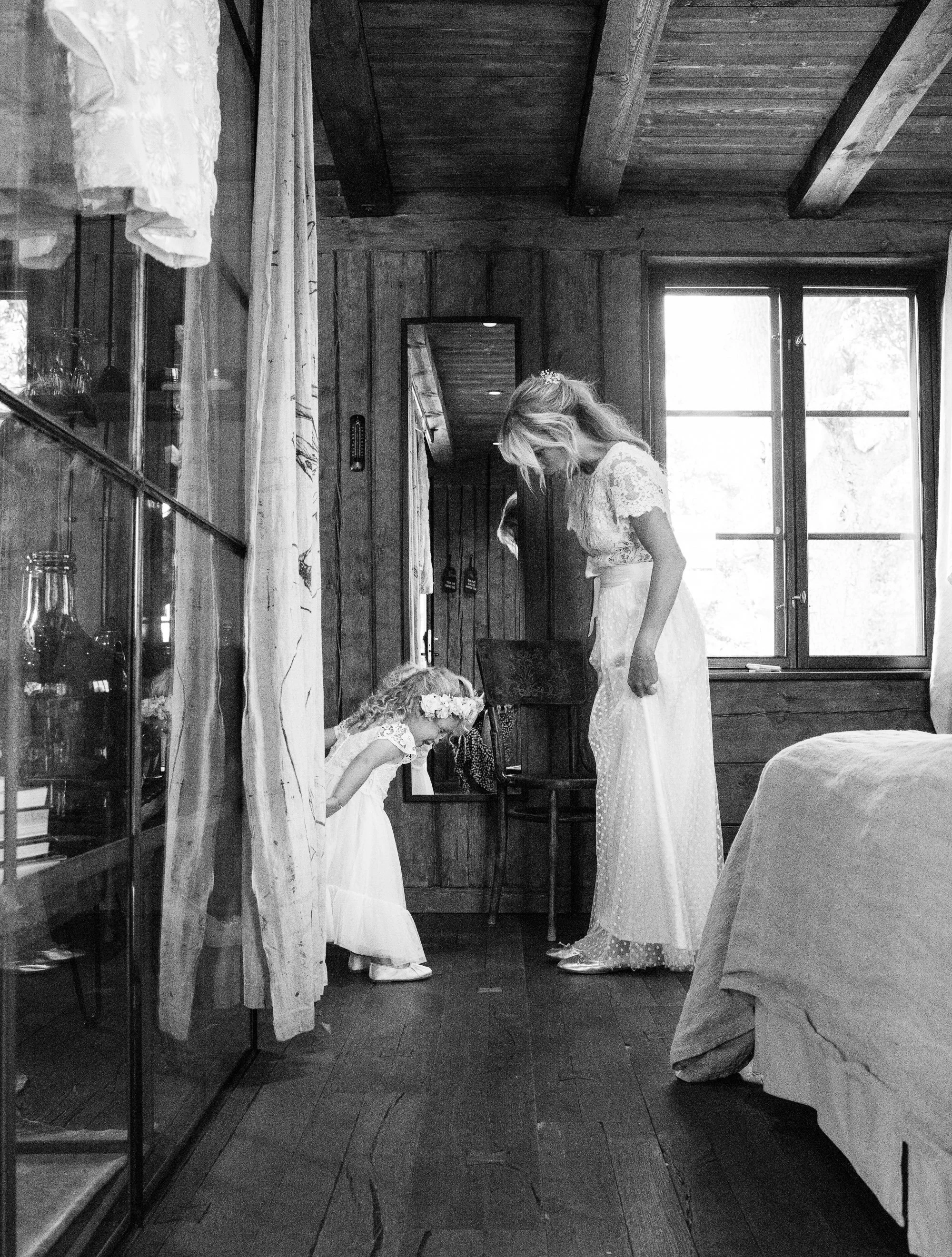 bride and bridesmaid looking at each others shoes wedding photography Stockholm