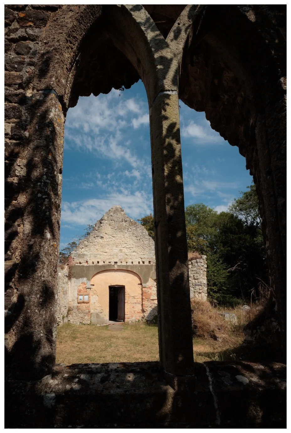 The Old Church at Greatham, viewed through one of the ruined, stone windows.