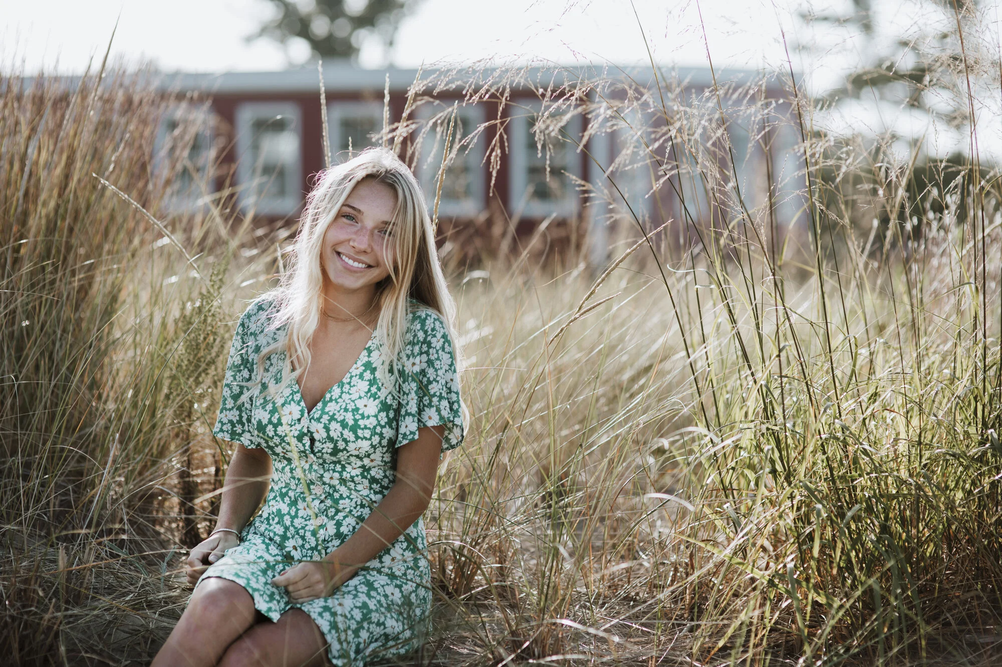 Lifestyle portrait of young woman in tall grass.