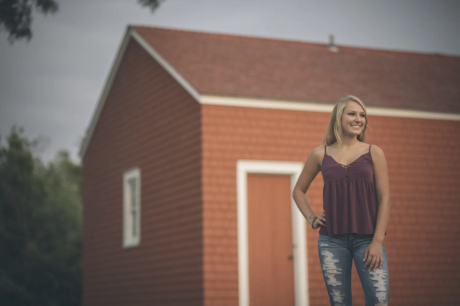 Lifestyle portrait beside historic red building.