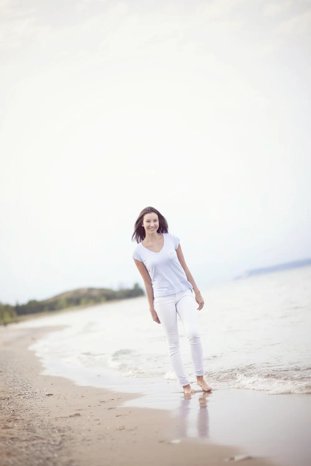 Lifestyle portrait walking along Lake Michigan shoreline.