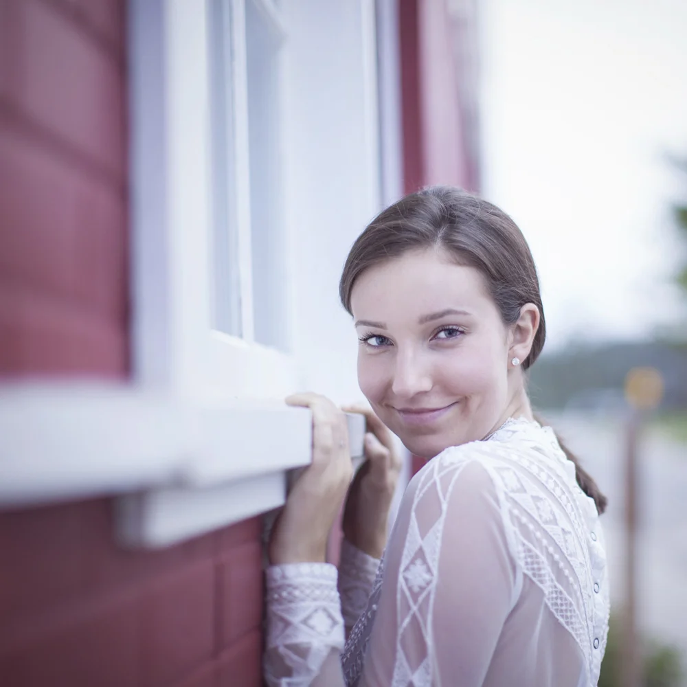 Natural light portrait beside historic Glen Haven building.
