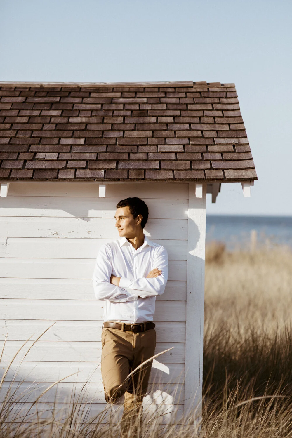 Environmental portrait outside historic white cottage in Sleeping Bear Dunes.