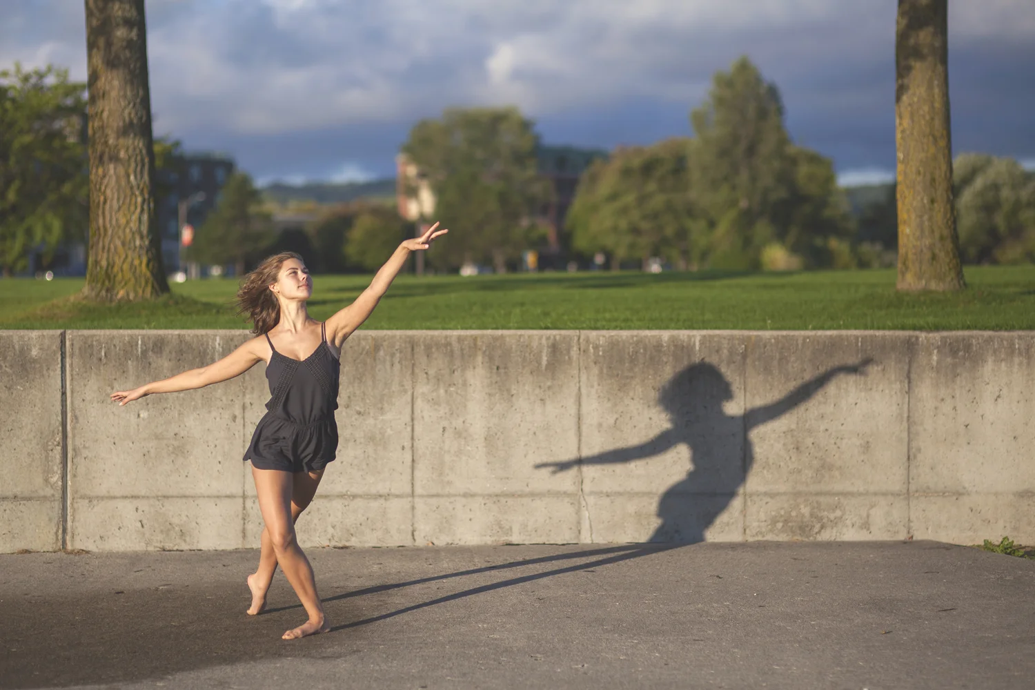 Dance portrait casting shadow at sunset.