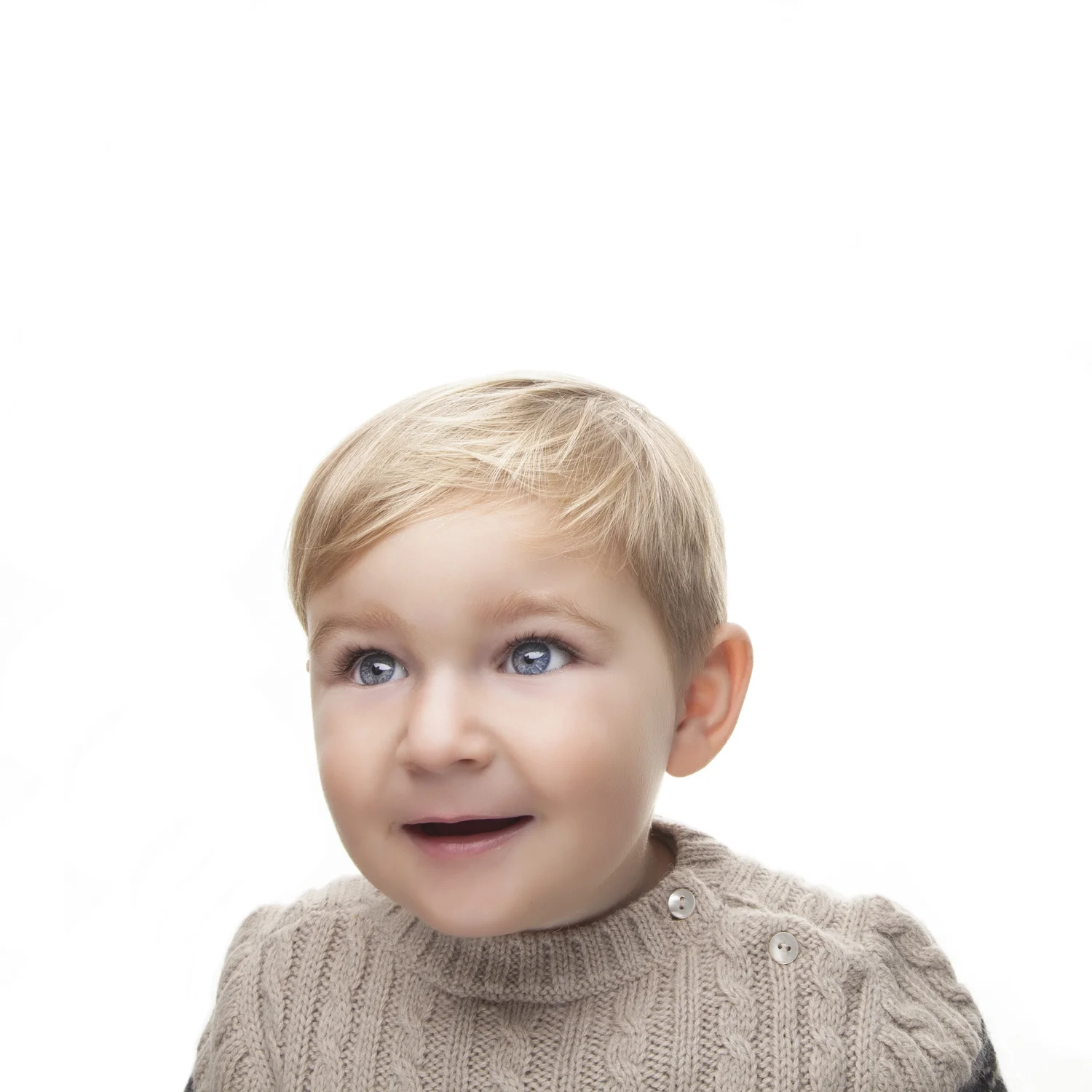 High-key portrait of smiling toddler.