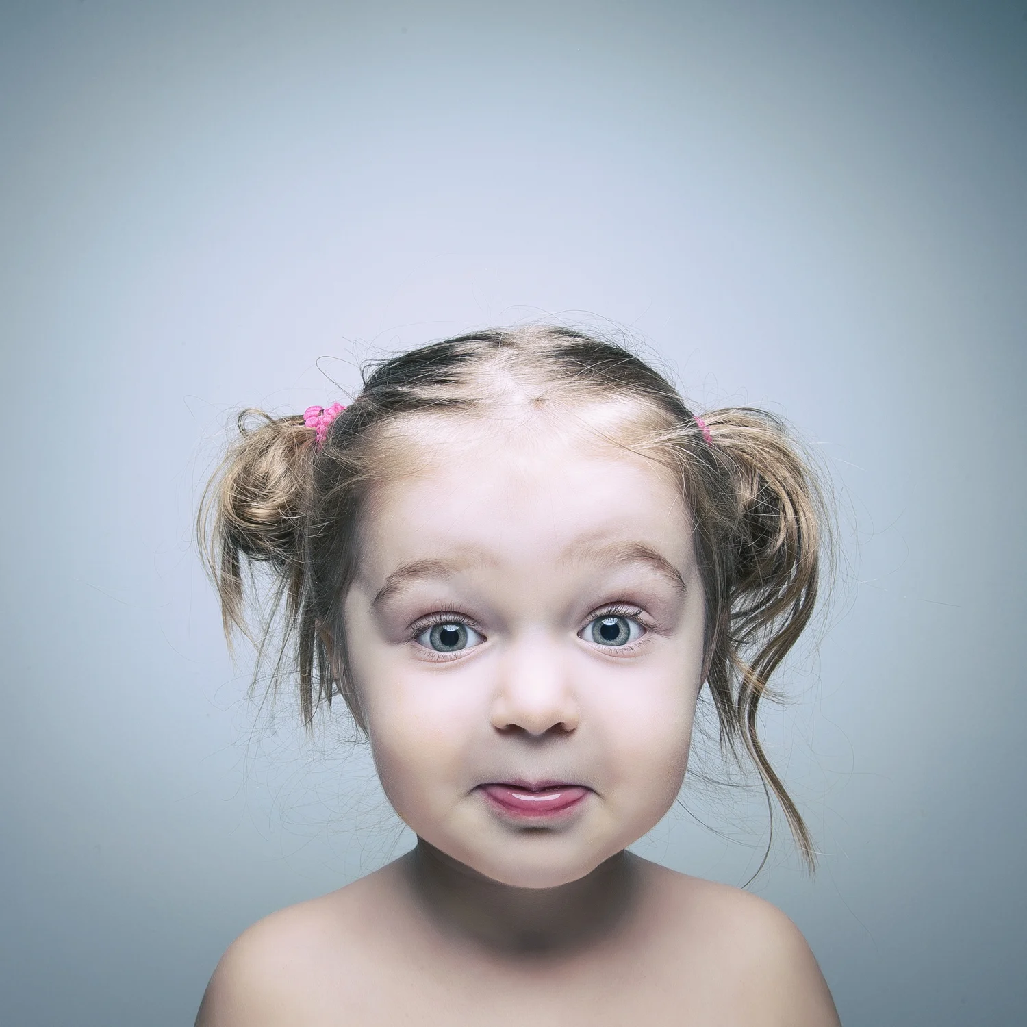 Studio portrait of young girl with pigtails.