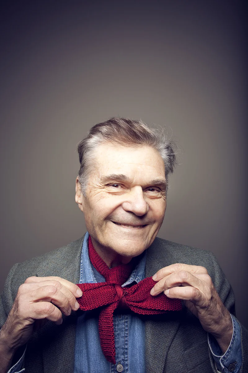 Portrait of actor Fred Willard adjusting scarf.