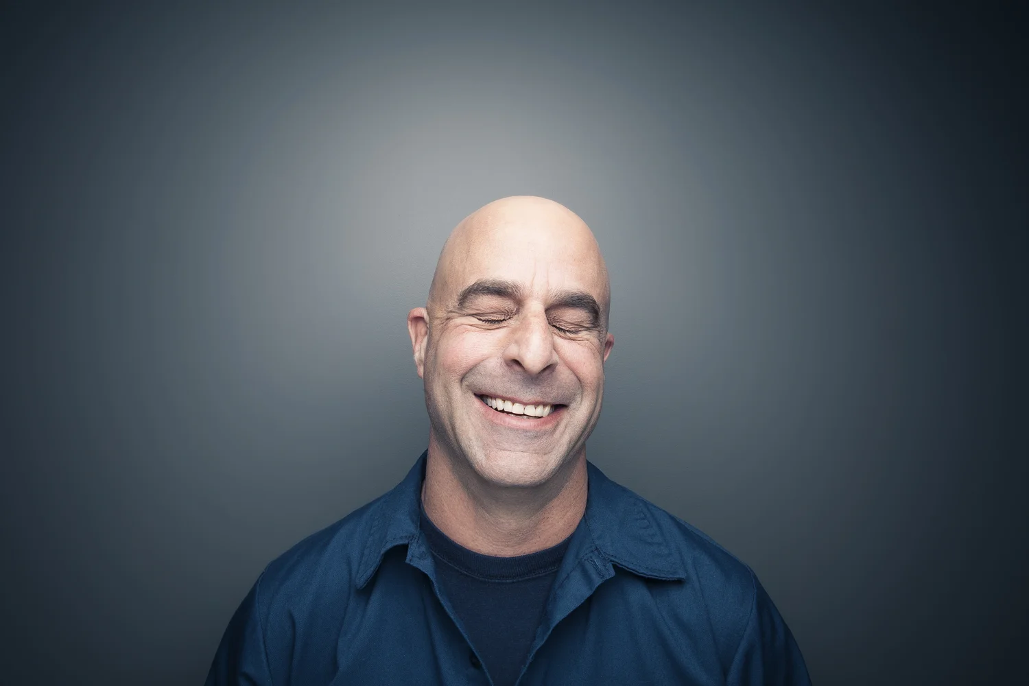 Studio portrait of smiling bald man.