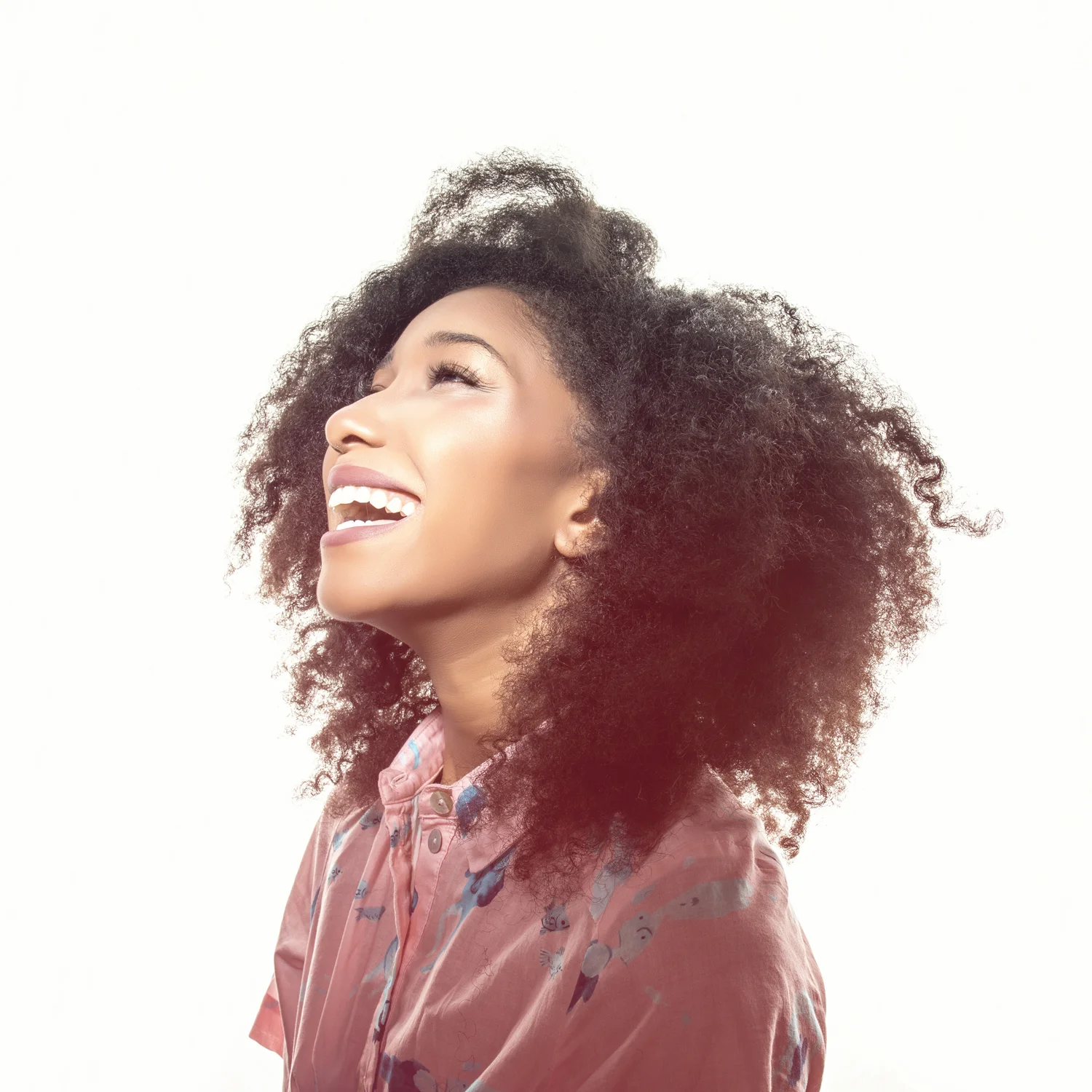 High-key portrait of smiling woman.
