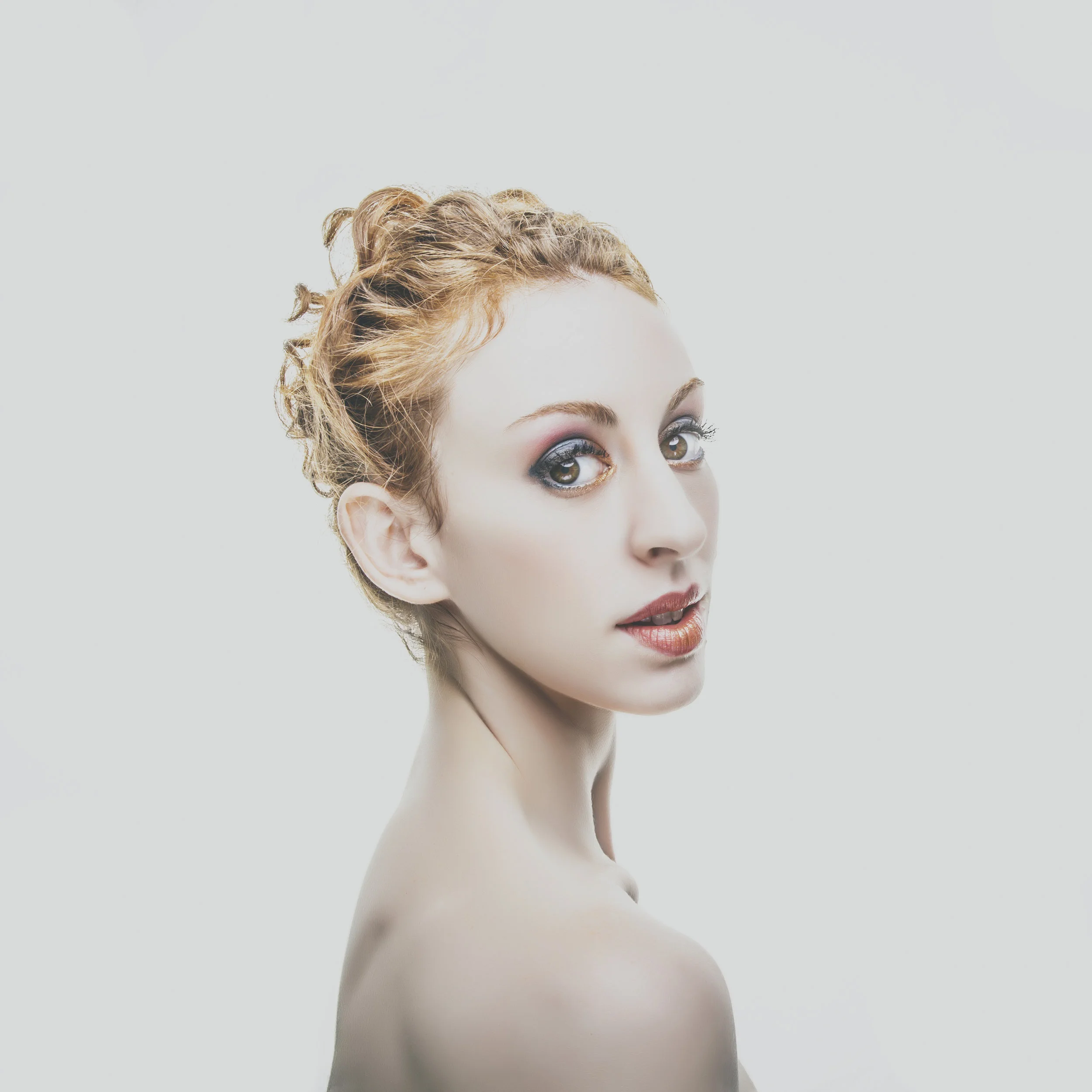 High-key beauty portrait of ballet dancer with braided hair.