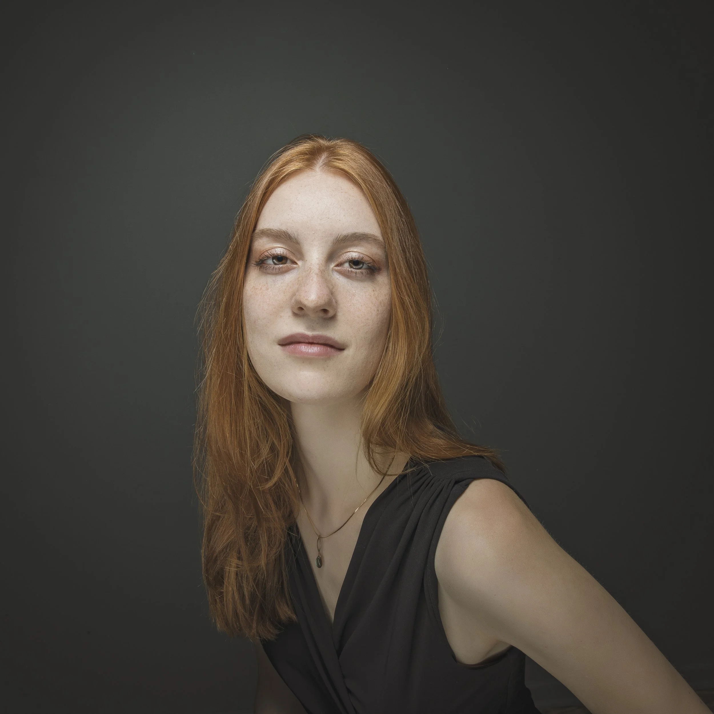 Editorial portrait of red-haired woman.