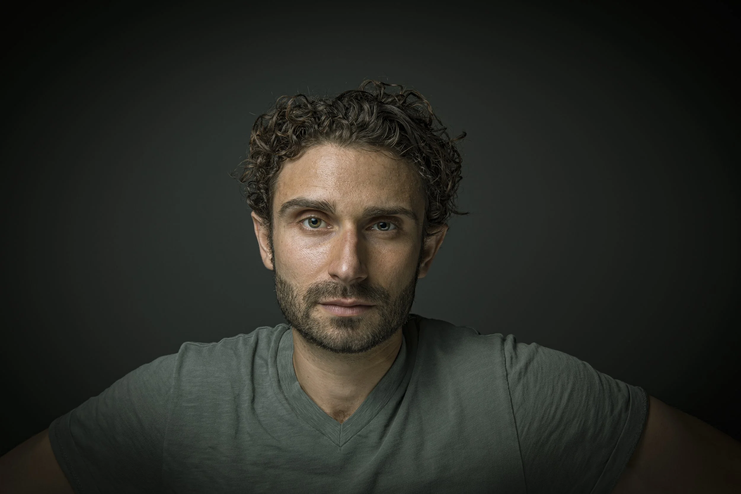 Editorial portrait of man with curly hair.