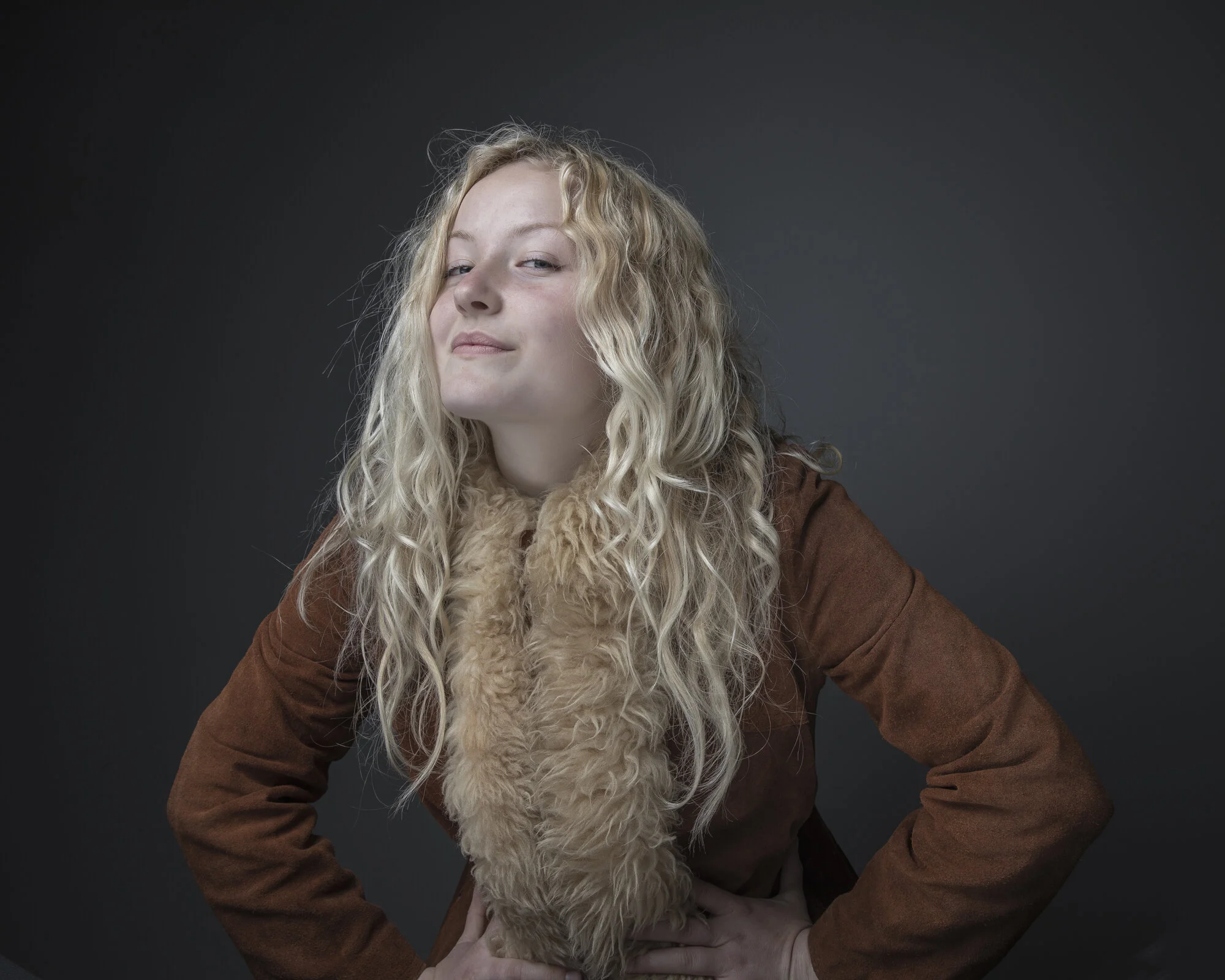 Relaxed portrait of young woman with long blonde hair.