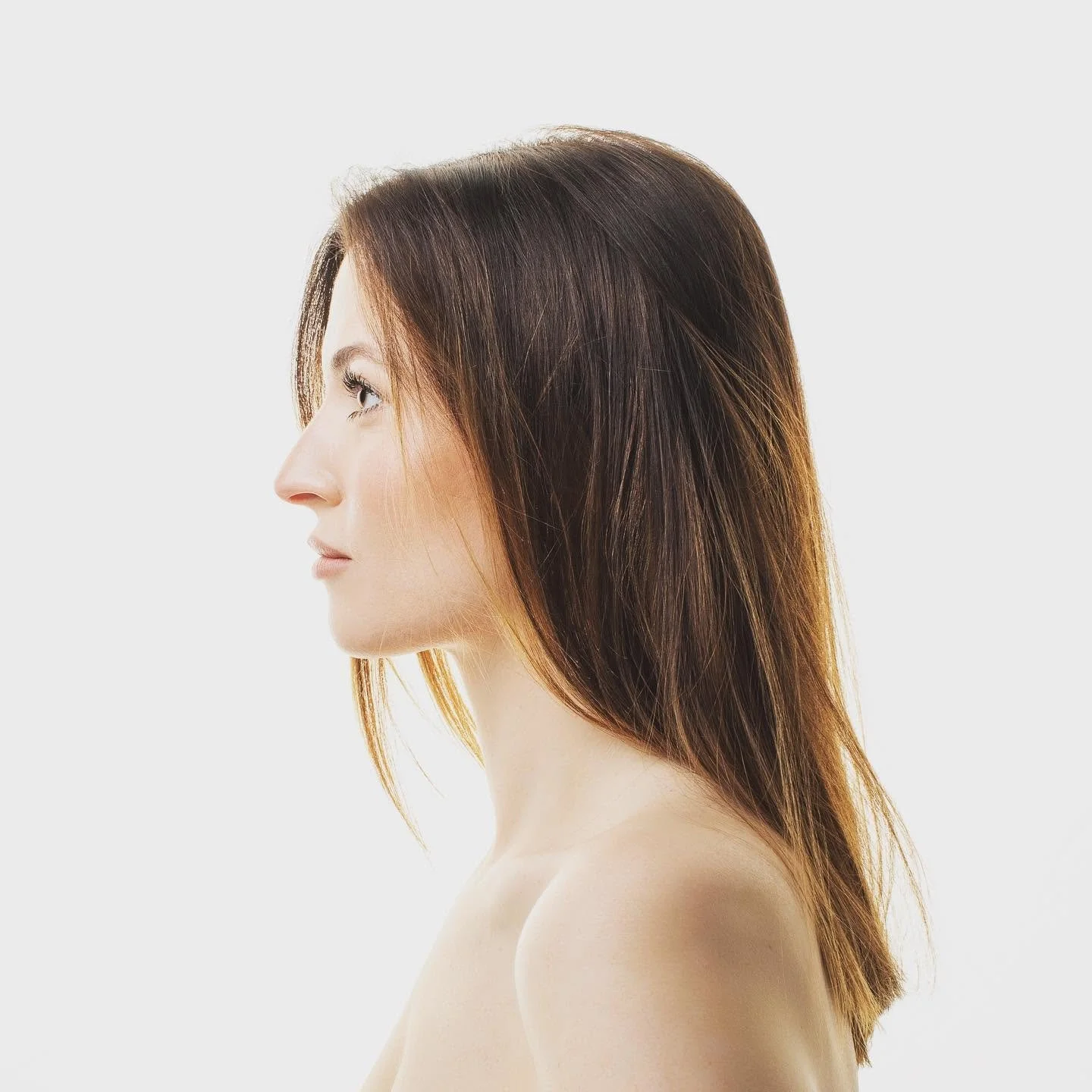 Minimalist profile portrait of woman on white background.