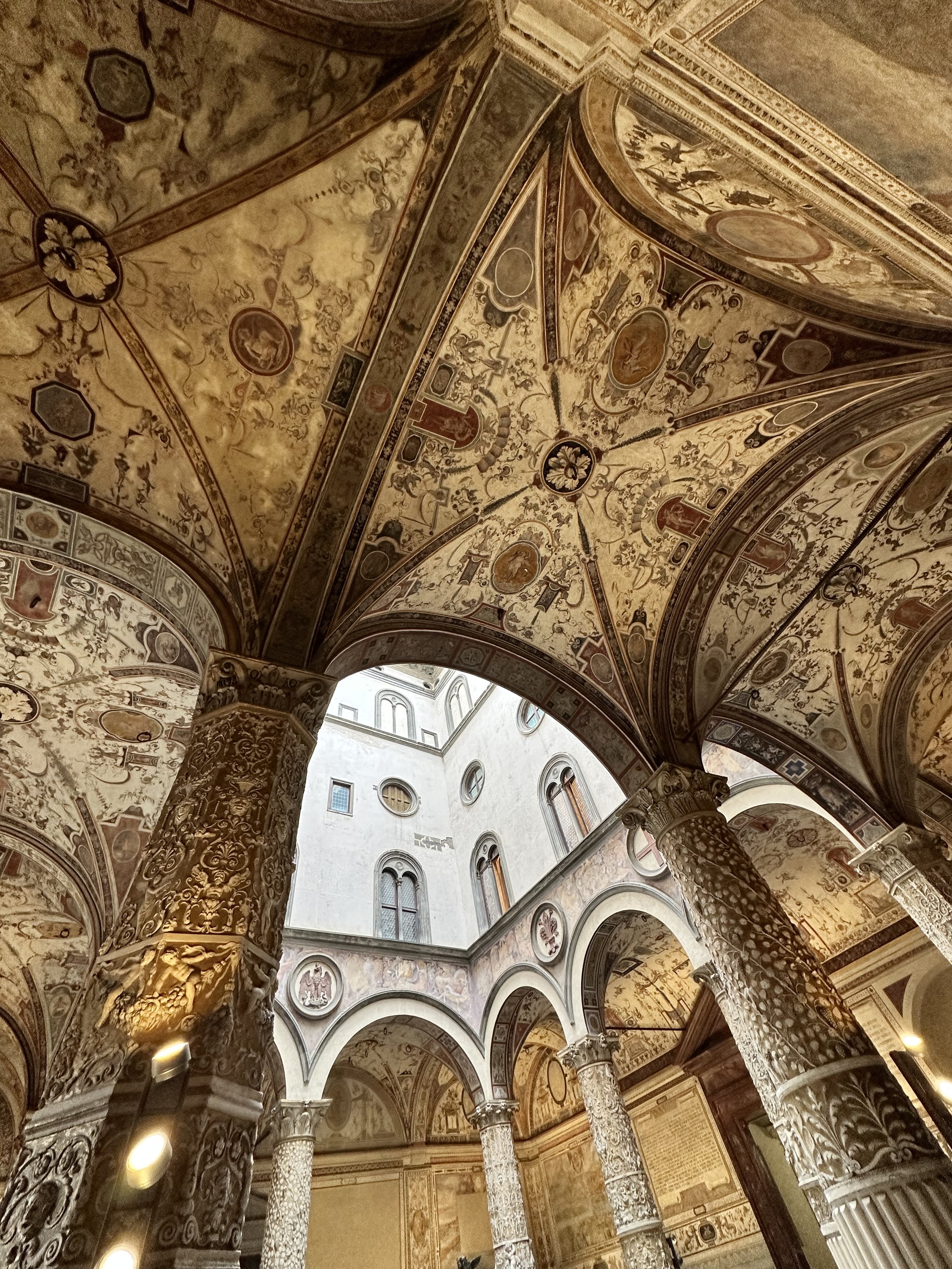 Architectural photograph of historic Renaissance courtyard in Florence, Italy.