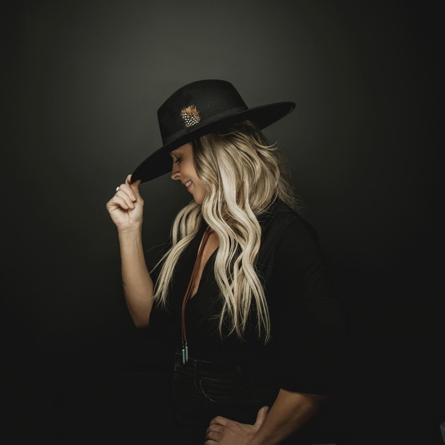 Editorial portrait of woman wearing black hat.