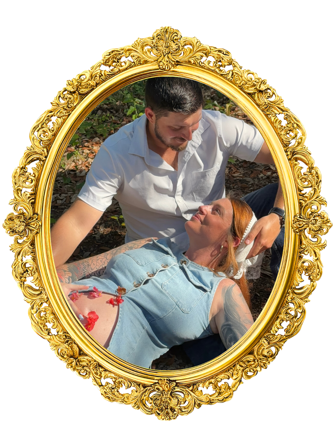 A man and woman lying on the ground outdoors, framed by an ornate gold frame. Maternity and lifestyle content creation in Jacksonville Florida The background consists of green foliage and brown soil.