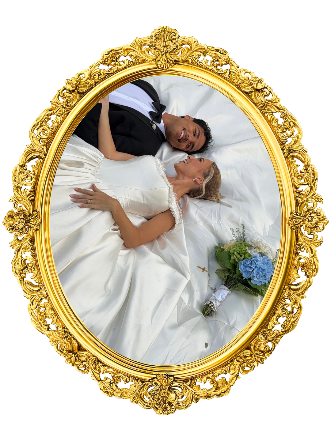 A bride and groom lying on a bed, smiling and looking at each other, seen through an ornate gold mirror. Florida elopement content creator