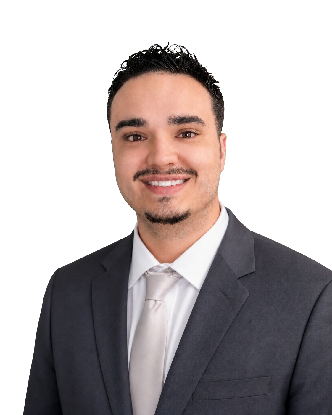 Portrait of a young man in a dark gray suit, white shirt, and light-colored tie, smiling with short dark curly hair and a mustache, against a plain background.