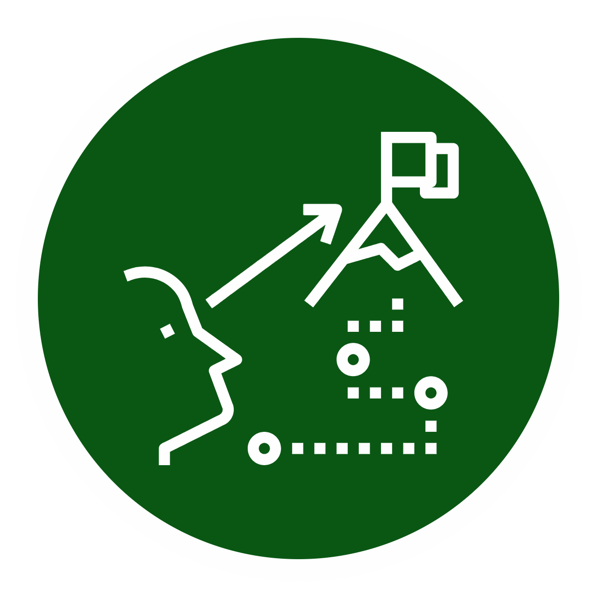 A circular badge with a dark green background and white outlines showing a person's profile, a mountain with a flag, an arrow, and strategic game symbols, representing strategic thinking or planning.