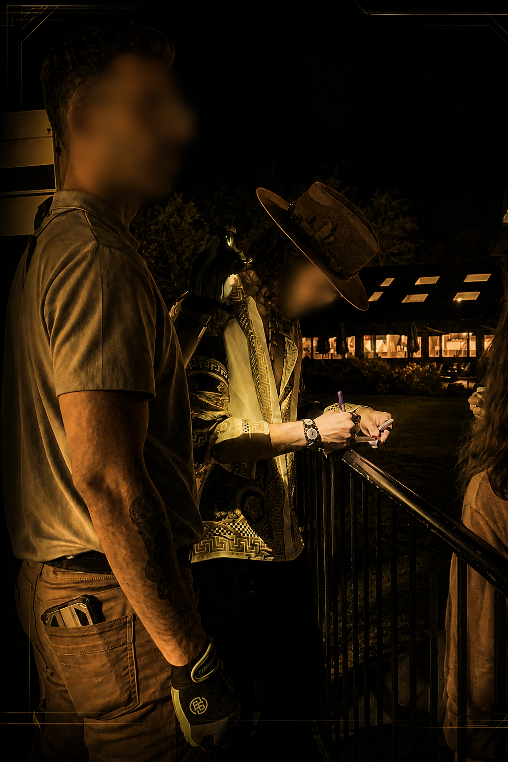 People standing near a railing at night, one person wearing a wide-brimmed hat and patterned jacket and a Monarch executive protection agent keeping watch on the crowd..