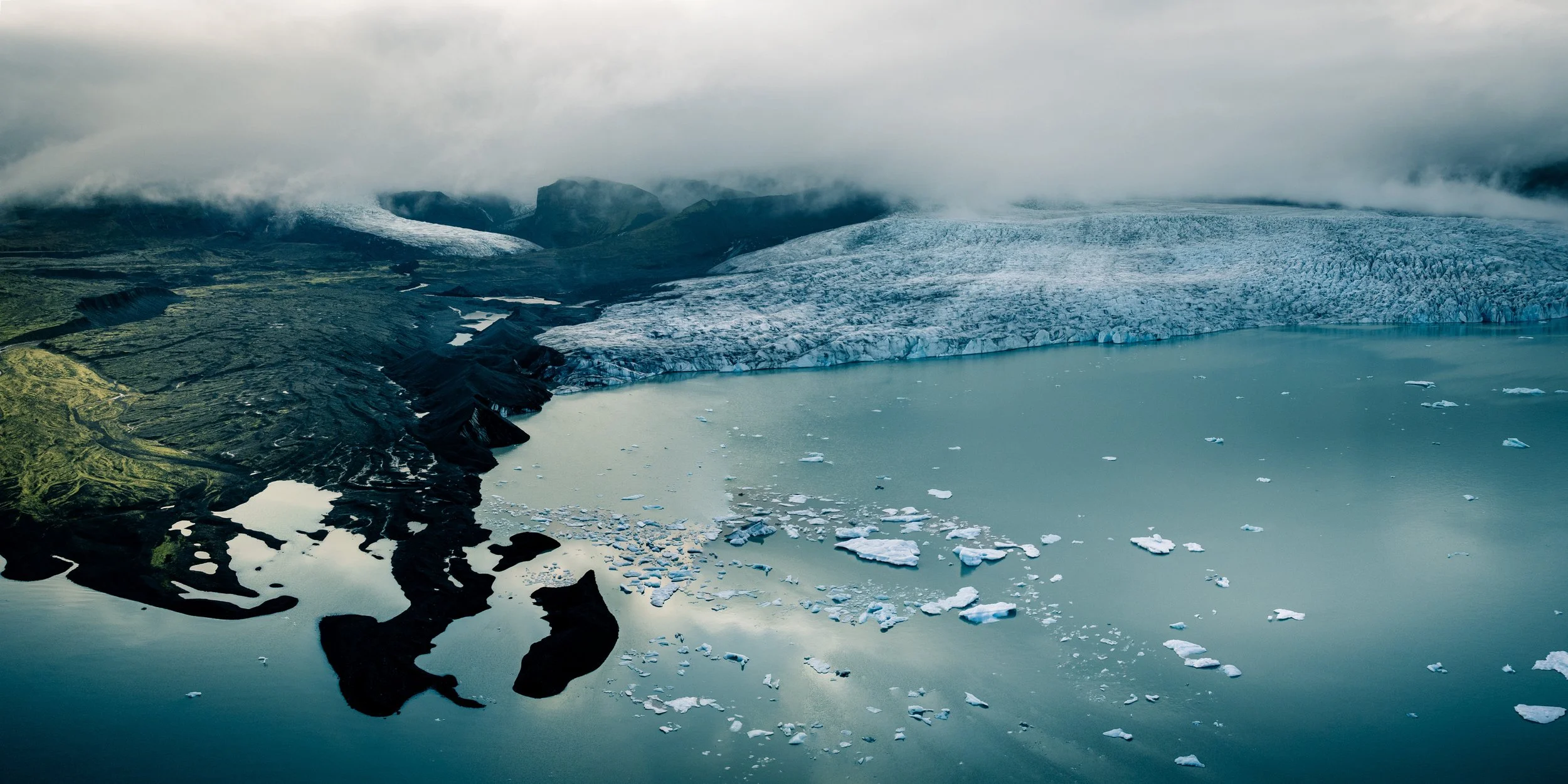 Panoramic aerial view of Fjallsárlón glacier lagoon with floating icebergs in Iceland