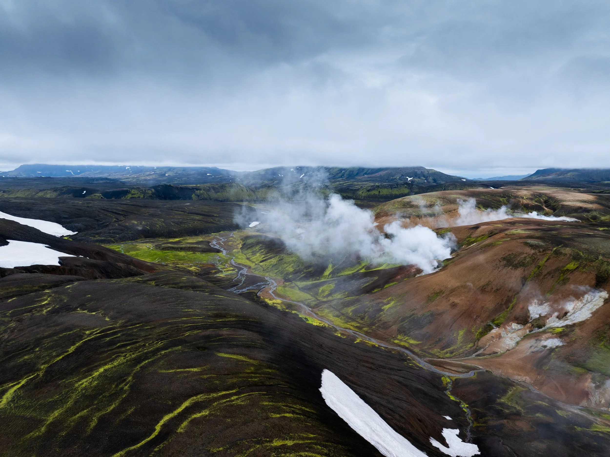 Volcanic landscape and geothermal steam along the Laugavegur trail near Landmannalaugar, Iceland