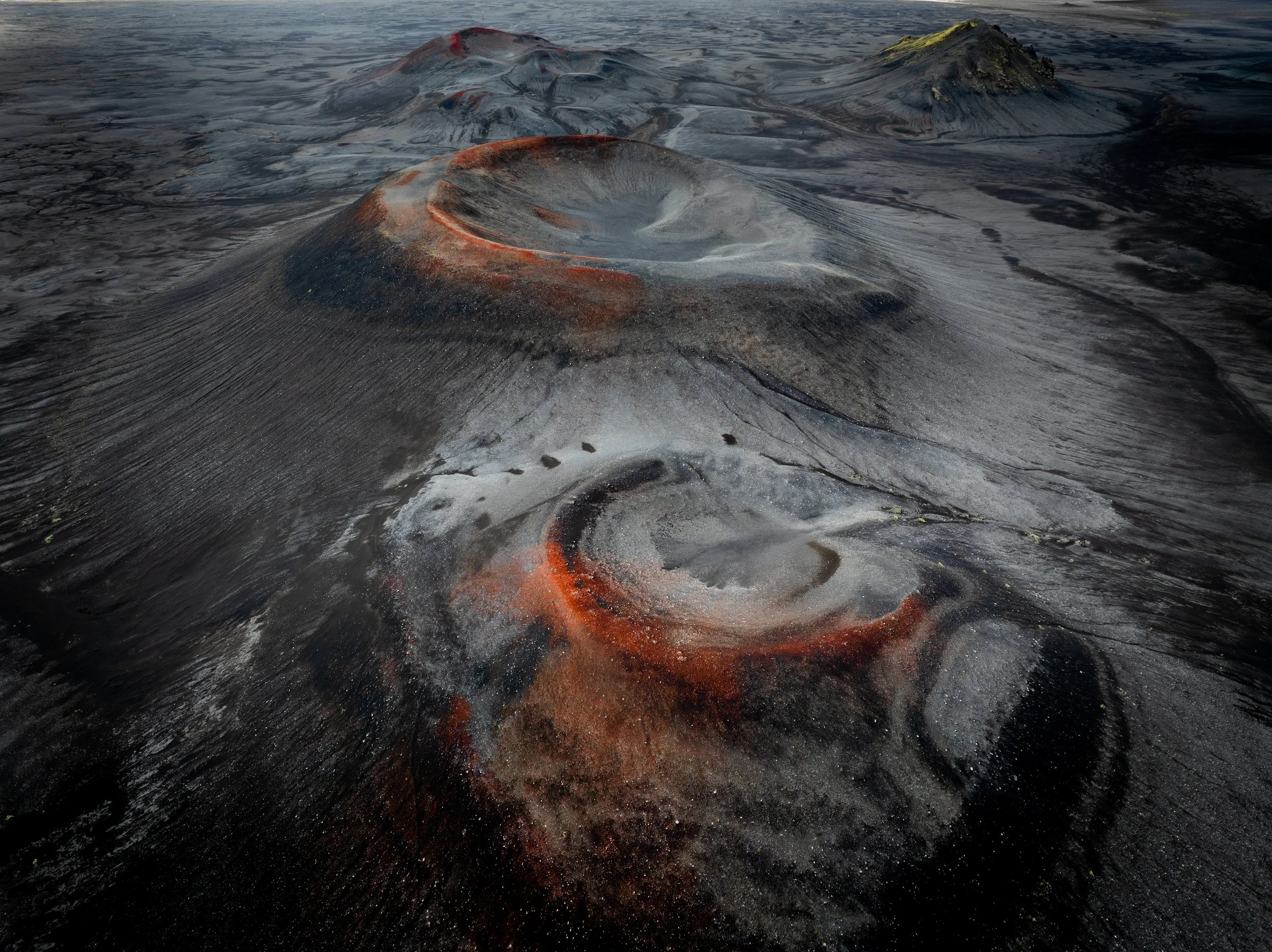 Aerial view of volcanic craters and dark volcanic terrain in the Icelandic Highlands