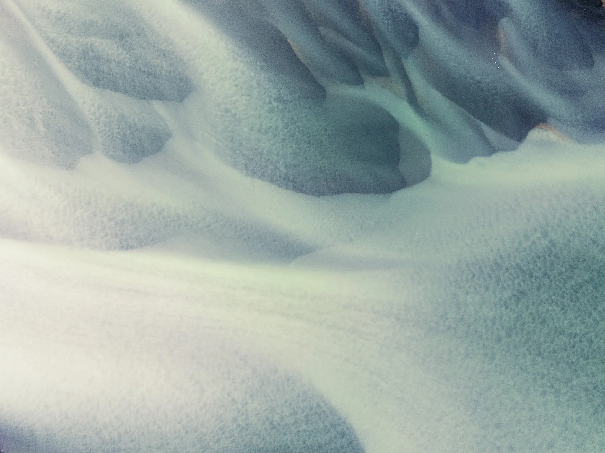 Abstract aerial view of fine glacial sediments forming layered patterns in Iceland