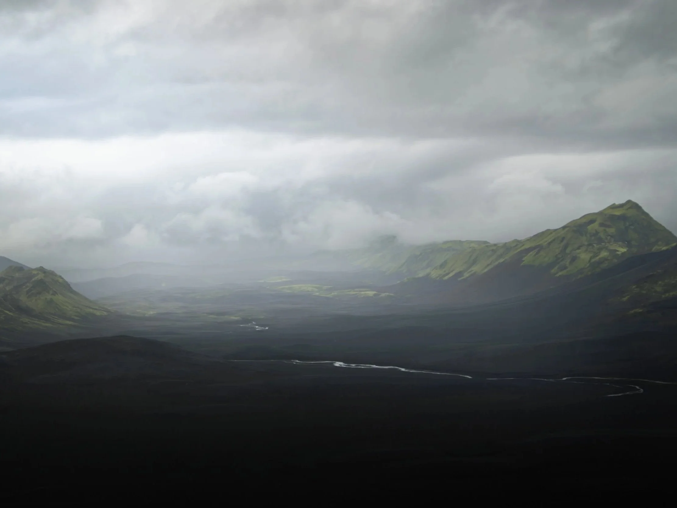 Vast volcanic landscape near Langisjór in the Icelandic Highlands with distant green mountains and a winding river