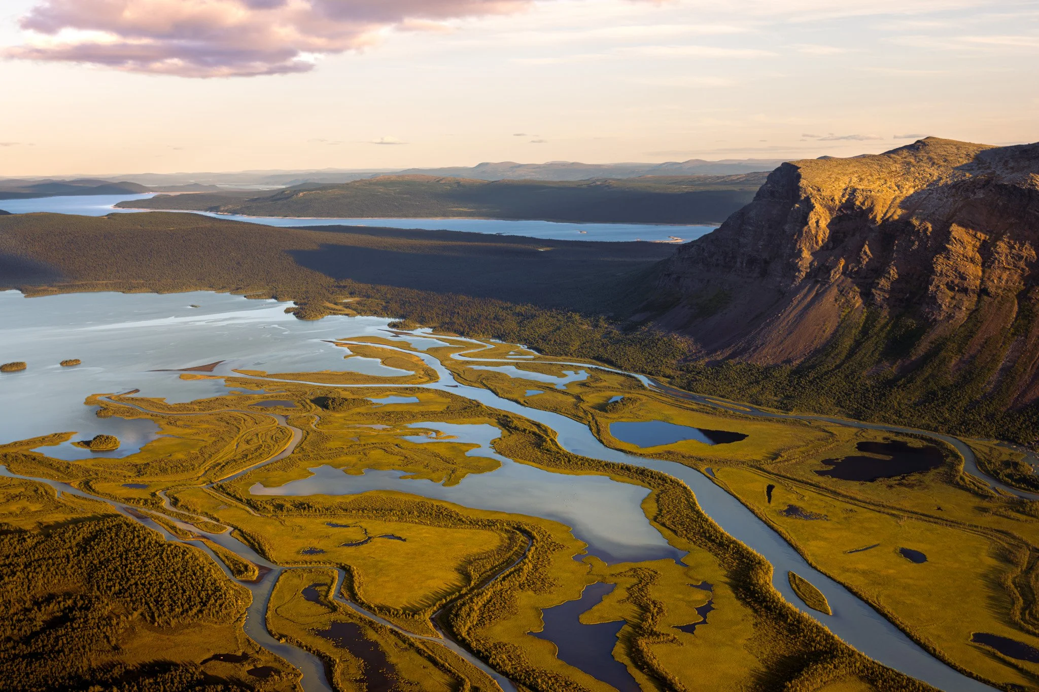Aerial view of the Rapadalen valley and Rapadelta in Swedish Lapland, surrounded by rugged mountains