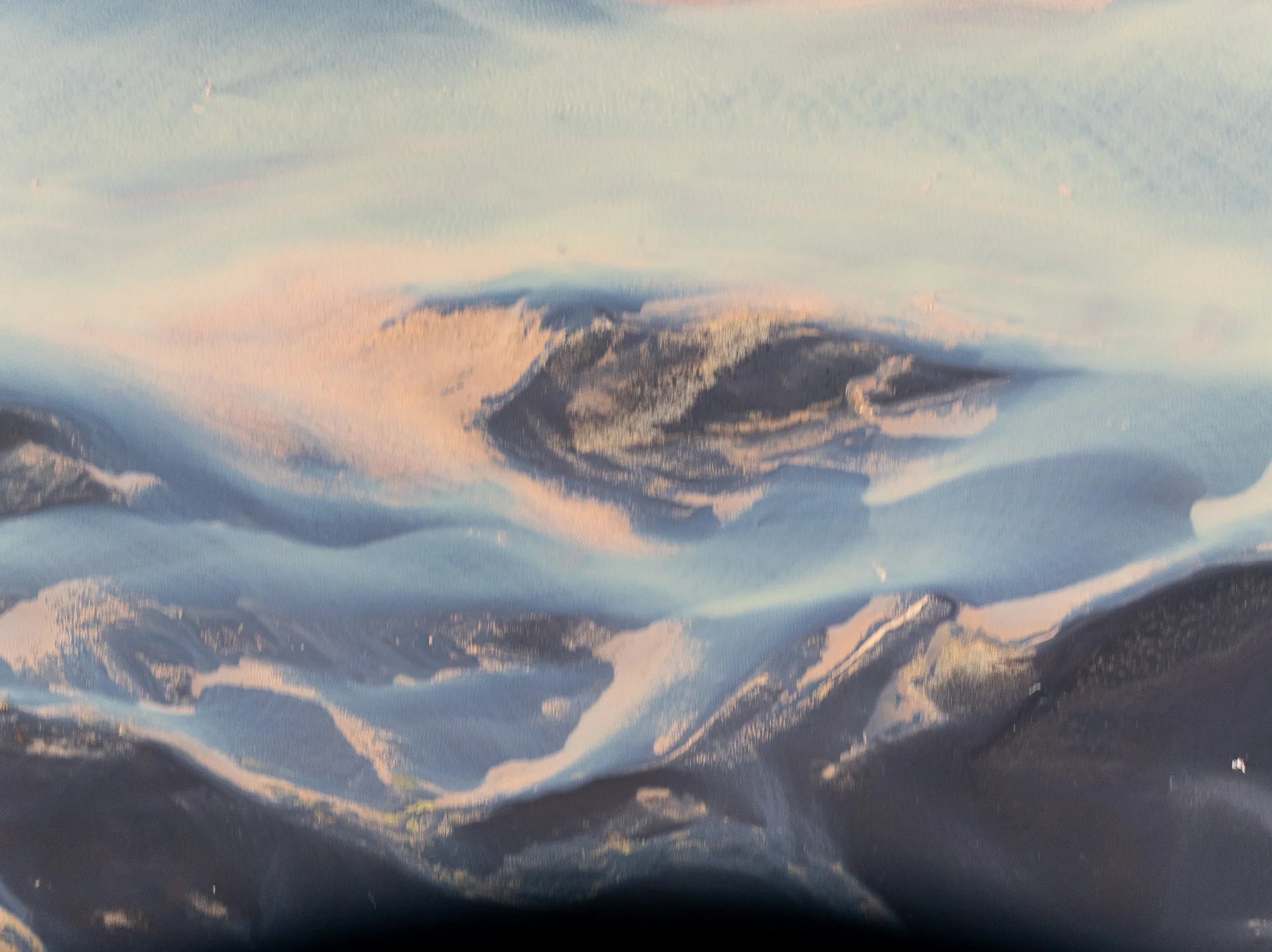 Aerial view of a glacial river flowing through the Icelandic landscape