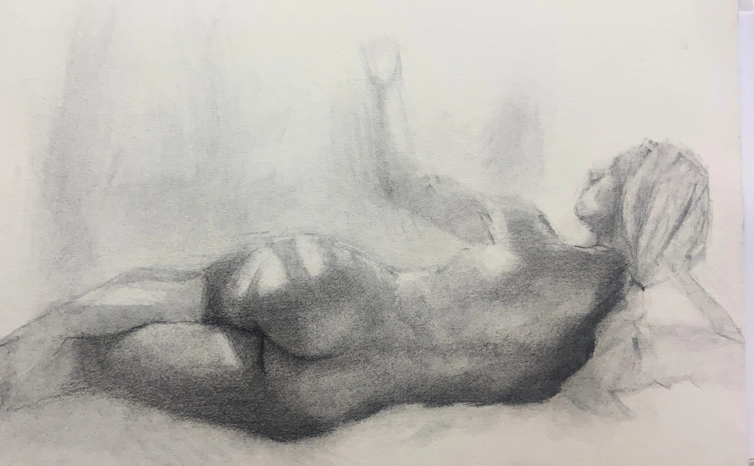 A pencil sketch of a nude woman lying on her side on the floor with her back to the viewer, her legs extended and her arms bent behind her head.